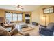 Comfortable living room with a fireplace, tile flooring, a ceiling fan, and plenty of room for seating at 2235 Well Springs Dr Dr, Buford, GA 30519