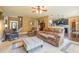 Inviting living room showcasing tile flooring, a ceiling fan, and an open floor plan to the kitchen at 2235 Well Springs Dr Dr, Buford, GA 30519