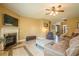 Cozy living room features a fireplace, tile flooring, ceiling fan, and ample seating at 2235 Well Springs Dr Dr, Buford, GA 30519