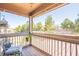Covered porch with wood flooring offering views of the backyard trees and landscape at 2235 Well Springs Dr Dr, Buford, GA 30519