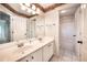 Elegant bathroom featuring double sinks, white cabinetry, and framed mirrors at 65 Orchard Dr, Covington, GA 30014