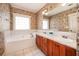 Bathroom featuring double vanity, soaking tub and wallpaper at 65 Orchard Dr, Covington, GA 30014