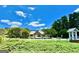 A beautiful community entrance with lush greenery, mature trees and landscaping, enhancing curb appeal at 65 Orchard Dr, Covington, GA 30014