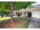 Well-maintained single story home with attached garage, porch, and beautiful mature trees at 65 Orchard Dr, Covington, GA 30014