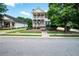 Charming two-story home featuring a welcoming porch, mature landscaping, and inviting curb appeal at 65 Orchard Dr, Covington, GA 30014