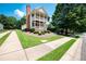 Traditional-style home featuring a chimney, double balconies, and a landscaped yard at 65 Orchard Dr, Covington, GA 30014