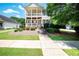 Charming two-story home featuring double balconies and a well-manicured front yard at 65 Orchard Dr, Covington, GA 30014