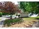 Beautifully landscaped front yard featuring vibrant foliage and a well-manicured lawn at 65 Orchard Dr, Covington, GA 30014