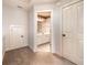 Hallway showing bathroom access, storage closet, and another closet at 65 Orchard Dr, Covington, GA 30014