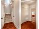 Hallway featuring hardwood floors, a staircase and a closet in a neutrally decorated home at 65 Orchard Dr, Covington, GA 30014