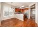Open kitchen with stainless steel appliances, wooden cabinets, and a connecting breakfast nook with a window at 65 Orchard Dr, Covington, GA 30014
