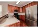 Kitchen with stainless steel appliances and wood cabinets and cream tile backsplash at 65 Orchard Dr, Covington, GA 30014