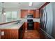 Kitchen features stainless steel refrigerator and wood cabinets, backsplash and black appliances at 65 Orchard Dr, Covington, GA 30014