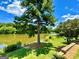 Picturesque lake view with lush trees, well-maintained grounds and walking path at 65 Orchard Dr, Covington, GA 30014