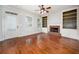 Bright living room featuring hardwood floors, fireplace, and built-in shelving at 65 Orchard Dr, Covington, GA 30014
