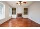 Spacious living room with hardwood floors, a cozy fireplace, and built-in bookcases at 65 Orchard Dr, Covington, GA 30014