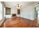 Open-concept living room with a fireplace, built-in shelving, and hardwood floors at 65 Orchard Dr, Covington, GA 30014
