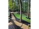 Stone steps lead to a manicured backyard with a firepit and a natural wooded setting at 126 Laguna Springs Dr, Woodstock, GA 30188