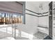 Bright shower area featuring white subway tile, a built-in bench, and large window at 126 Laguna Springs Dr, Woodstock, GA 30188