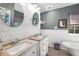 Bathroom features dual vanities, oval mirrors, and stylish decor at 126 Laguna Springs Dr, Woodstock, GA 30188