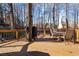 Outdoor deck area with wood flooring, outdoor furniture, an umbrella, and a grill for convenient outdoor dining and entertaining at 126 Laguna Springs Dr, Woodstock, GA 30188