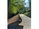 Long driveway landscaped with rocks, mulch, and shrubbery at 126 Laguna Springs Dr, Woodstock, GA 30188