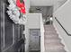 Light-filled entryway with staircase and view into the open concept kitchen at 126 Laguna Springs Dr, Woodstock, GA 30188