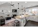 Open-concept kitchen with white cabinetry, granite countertops, stainless appliances, and a view into the cozy living area at 126 Laguna Springs Dr, Woodstock, GA 30188