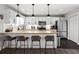 Bright kitchen features white cabinets, stainless steel appliances, and a granite countertop island with barstool seating at 126 Laguna Springs Dr, Woodstock, GA 30188