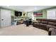 Living room with green walls, comfortable seating, desk and TV at 126 Laguna Springs Dr, Woodstock, GA 30188