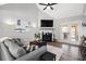Bright living room with fireplace, modern decor, and plenty of comfortable seating at 126 Laguna Springs Dr, Woodstock, GA 30188