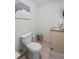 Powder room featuring a toilet, wall art, and sink with marble countertop at 126 Laguna Springs Dr, Woodstock, GA 30188