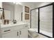 Modern bathroom with a glass enclosed shower, neutral tile, and white vanity at 1590 Branthaven Ln, Auburn, GA 30011