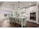 Bright kitchen with stainless steel appliances, a marble island with barstool seating, and hardwood floors at 1590 Branthaven Ln, Auburn, GA 30011