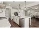 Open kitchen featuring a center island with a stainless steel dishwasher and view into the living room at 1590 Branthaven Ln, Auburn, GA 30011