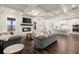 Open-concept living room with a fireplace, hardwood floors, lots of light, and adjoining kitchen at 1590 Branthaven Ln, Auburn, GA 30011