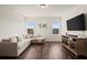 Cozy living room with a sectional sofa, television, and natural light at 1590 Branthaven Ln, Auburn, GA 30011