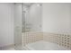 Tiled bathroom featuring a shower with glass door and tiled bathtub at 1820 Peachtree Nw St # 303, Atlanta, GA 30309
