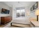 Light-filled bedroom features a wall mounted television, large windows and bright walls at 1820 Peachtree Nw St # 303, Atlanta, GA 30309
