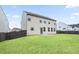 A view of the back of the house featuring a large backyard and neutral siding at 203 Creek View Ln, Acworth, GA 30102