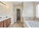 Bright bathroom features double vanity, bath tub, tile floors and walk-in closet at 203 Creek View Ln, Acworth, GA 30102