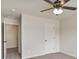A carpeted bedroom with a ceiling fan, a white door, and an entrance to another room at 203 Creek View Ln, Acworth, GA 30102