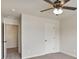This cozy bedroom features neutral walls, plush carpeting, and a ceiling fan with light fixture at 203 Creek View Ln, Acworth, GA 30102