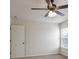 Bedroom featuring plush carpet, white door, and ceiling fan at 203 Creek View Ln, Acworth, GA 30102