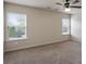 This spacious bedroom has plush carpeting, neutral walls, and natural light from two large windows at 203 Creek View Ln, Acworth, GA 30102