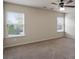A carpeted bedroom featuring two large windows with natural light and neutral walls at 203 Creek View Ln, Acworth, GA 30102