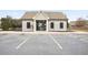 Exterior of a clubhouse with a parking lot in front and some trees surrounding it at 203 Creek View Ln, Acworth, GA 30102
