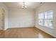 Bright dining room with hardwood floors, elegant wainscoting, and a large window offering ample natural light at 203 Creek View Ln, Acworth, GA 30102