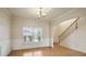 Elegant dining room with hardwood floors, wainscoting, and staircase access at 203 Creek View Ln, Acworth, GA 30102