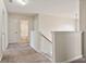 A bright hallway leads to a bathroom and bedroom, featuring plush carpeting and neutral walls at 203 Creek View Ln, Acworth, GA 30102
